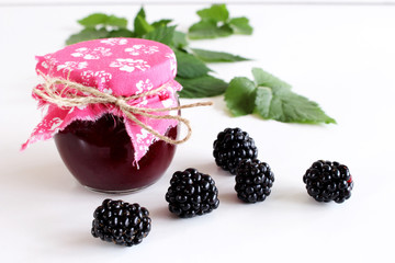 Jar of blackberry jam on white wooden background. . Delicious fruit . Blurred background.Food and healthy concept.
