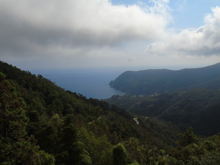 An amazing caption of the beautiful places from the 5 Terre in Liguria with an amazing blue sky and some green mountains in the background