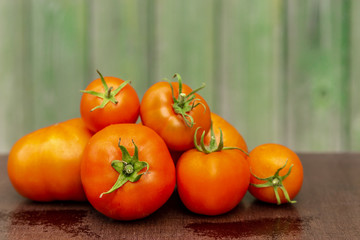 Soft tone bunch of tomatoes on the background of a wooden facade