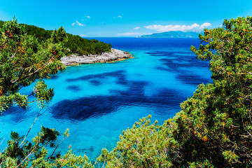 Azure hidden bay on greek island. Crystal clear water on sunny summerday