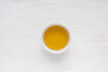 Liquid honey in a plate in the center of the table.