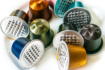 Several Used Aluminium Coffee Pods On A White Plate Several Used Aluminium Coffee Pods On A White Plate