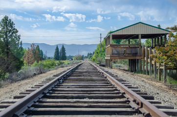 Fototapeta na wymiar Rural Mountain Railroad Platform Waiting for Train and Passengers