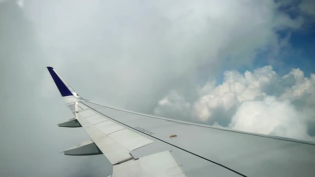 airplane fly through beautiful white clouds