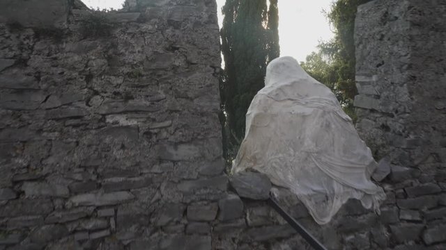 vezio castle, view over the lake and the alps mountains , inside of the old stone castle there are lot of sculpture of gosth