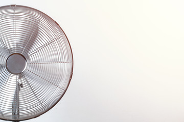 Fototapeta Close up of spinning fan with back sunlit. Summer heat concept obraz