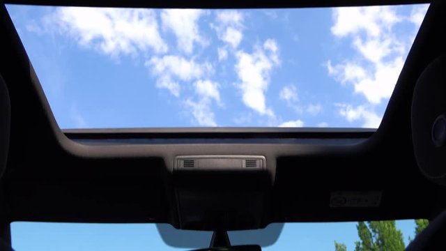 View at the sky through a car roof window