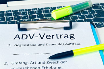 klemmbrett mit einem Vertrag und Aufschrift in deutsch ADV-Vertrag in english ADV-Vertrag und...