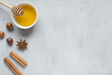 Honey liquid and anise with cinnamon on a light background. Copy space for text.