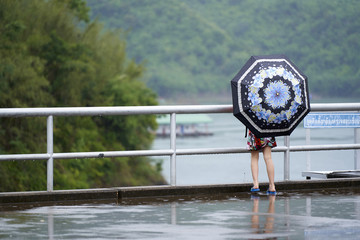 Child Holds Umbrella at Srinakarin Dam 