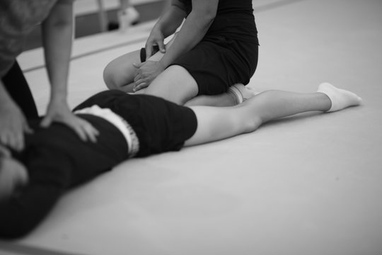 Manipulation on the spine and massage of the leg muscles at the gymnast after training
