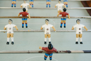 dolls of a retro foosball table to play table football