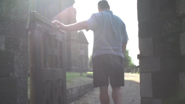 Man Walking Through Gate