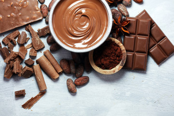 Melting chocolate  or melted chocolate with a chocolate swirl. Many stack and chips with powder.