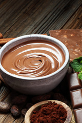 Melting chocolate  or melted chocolate with a chocolate swirl. Many stack and chips with powder.