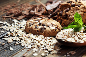 Chocolate cookies on rustic table. Chocolate chip cookies and cookies with oat flakes or oatmeal.