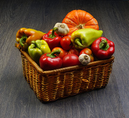 Fototapeta na wymiar vegetables in a basket on a wooden background