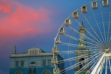 The Ferris wheel in the historical part of Kyiv on the Kontraktova Square on Podol in the evening, Kyiv, Ukraine