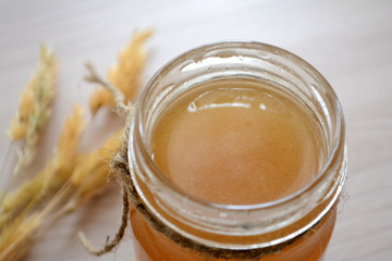 Honey in a transparent jar on the table