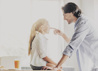 Young Smiling Father and Cute Daughter at Home.