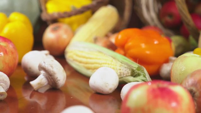 Autumnal Harvest or Thanksgiving, Cornucopia filled with vegetables, vegetables spilled out of the basket on the table. 4k, dolly shot