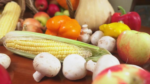 Autumnal Harvest or Thanksgiving, Cornucopia filled with vegetables, vegetables spilled out of the basket on the table. 4k, dolly shot