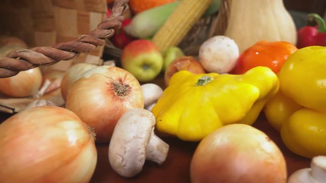 Autumnal Harvest or Thanksgiving, Cornucopia filled with vegetables, vegetables spilled out of the basket on the table. 4k, dolly shot