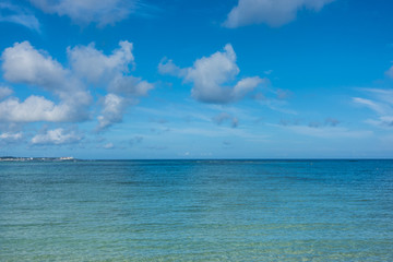 Tropical seascape, Turquoise Sea with Island under blue sky clouds, Travel Vacation, nature sea view in summer at Okinawa, Japan, nature background, copy space
