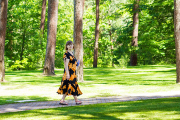 Happy senior woman walk in summer park