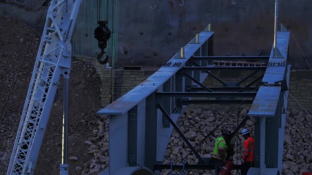 Iron workers building a bridge in the dark