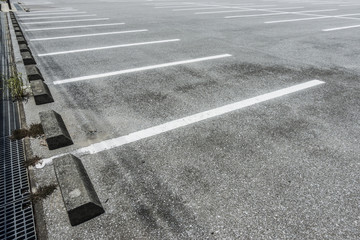 Fototapeta premium Empty parking lot with parking barrier, Vacant Parking Lot, Parking lane painting on floor, copy space