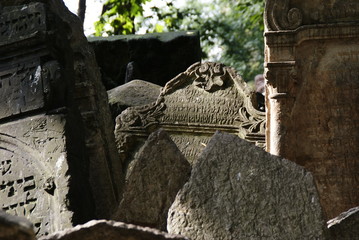 Historic old Jewish cemetery with rock tombs in Prague and broken monuments by the passage of time