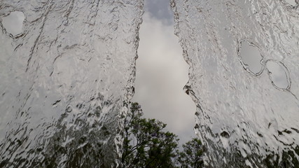 Wide stream of water falling in a semi-translucent park