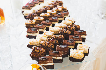Delicious sweets on wedding candy buffet with desserts, cupcakes