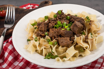 Stewed beef with tagliatelle pasta.