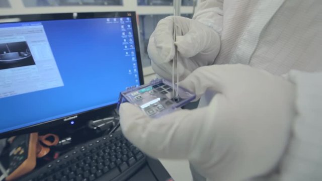 Scientists Working In A Nanofabrication Cleanroom Facility