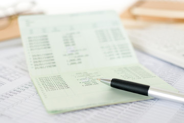 Close up of saving account passbook with pen and statement. Business and financial analysis...