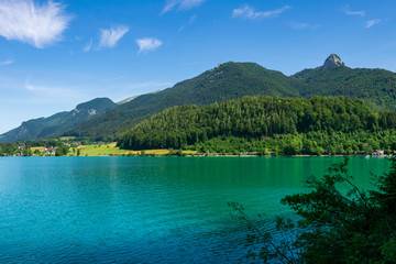 Lake called Wolfgangsee in Austria with Mountains in the Background and Clouds on the Sky