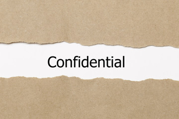 Fototapeta na wymiar The word confidential appearing behind torn paper.