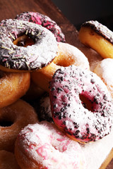 assorted donuts with chocolate frosted, pink glazed and sprinkle