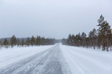 Obraz na płótnie Canvas Snowy day on the road in Finland