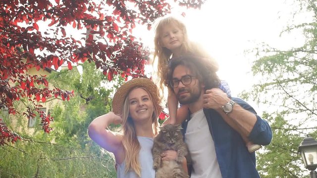 Beautiful caucasian family with daughter down the stairs, walking on picnic