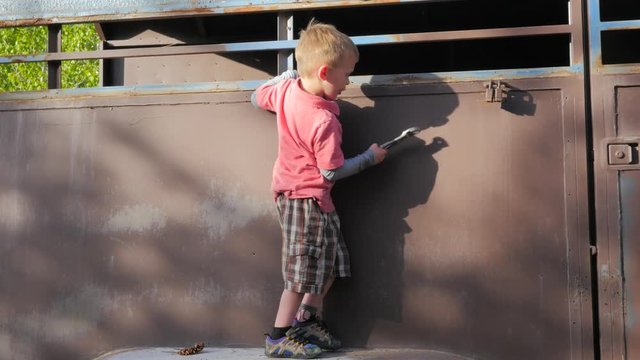 Young kid pretending to work on a trailer with pliers