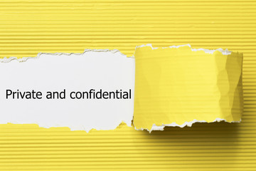 The word Private and confidential appearing behind torn paper.