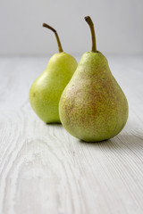 Sweet pears on a white wooden background, side view. Closeup.