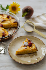 Piece of homemade peaches pie on a plate. Selective focus.