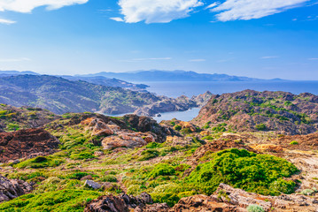 Fototapeta na wymiar Sea landscape with Cap de Creus, natural park. Eastern point of Spain, Girona province, Catalonia. Famous tourist destination in Costa Brava. Sunny summer day with blue sky and clouds