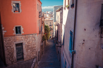 Fototapeta na wymiar Street in Girona, Catalonia, Spain. Scenic and colorful ancient town. Famous tourist resort destination, perfect place for holiday and vacation.