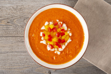 Soup gazpacho. Italian cuisine. Plate with soup in a white plate on a rustic background. Top Vieux. Copy space.