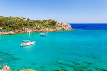 Fototapeta na wymiar Sea skyview landscape photo Ladiko bay near Anthony Quinn bay on Rhodes island, Dodecanese, Greece. Panorama with nice sand beach and clear blue water. Famous tourist destination in South Europe